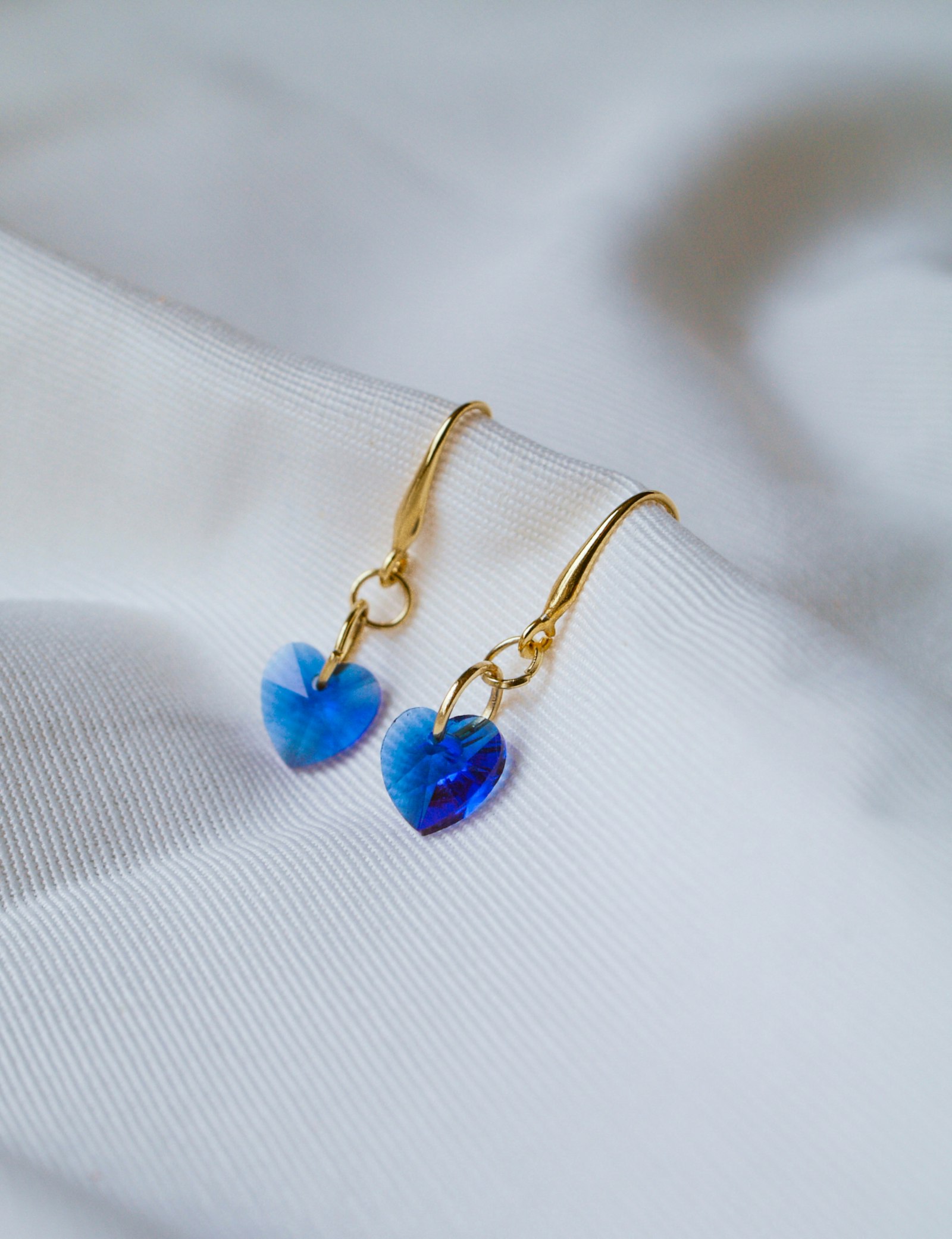 Gold hook earrings with blue heart crystal drops